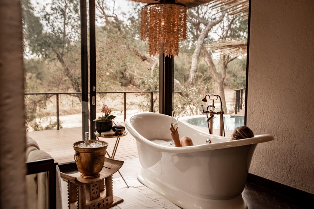 Lady in bath in luxury safari lodge