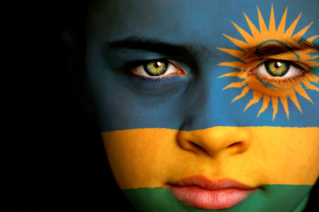 kid's face painted with rwanda flag - visit Rwanda