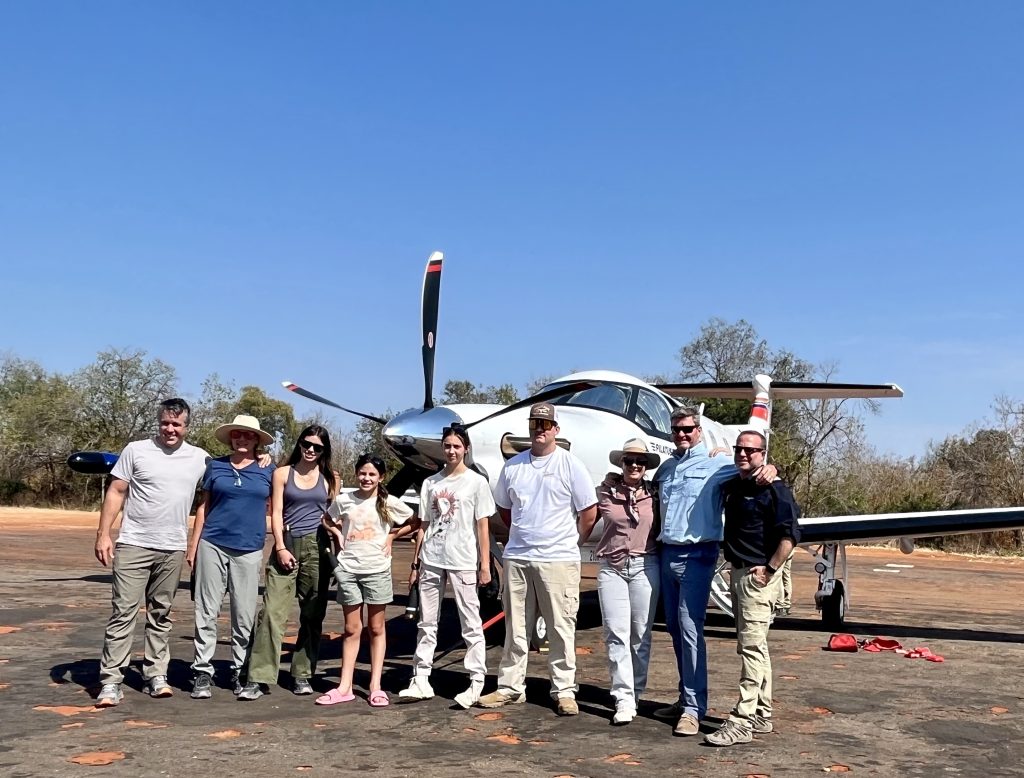 Family group in front of Pilatus PC12 aircraft on safari